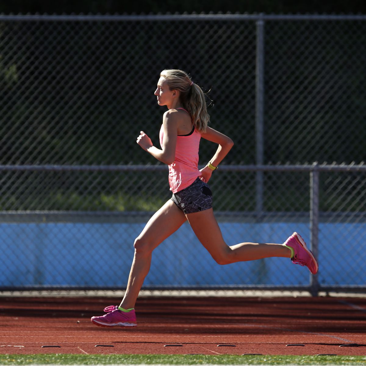 a female athlete runs on a track
