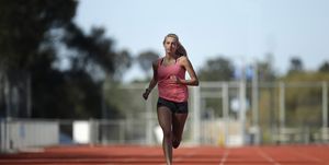 hiit training, high intensity interval training, a female athlete runs on a track
