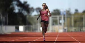 hiit training, high intensity interval training, a female athlete runs on a track