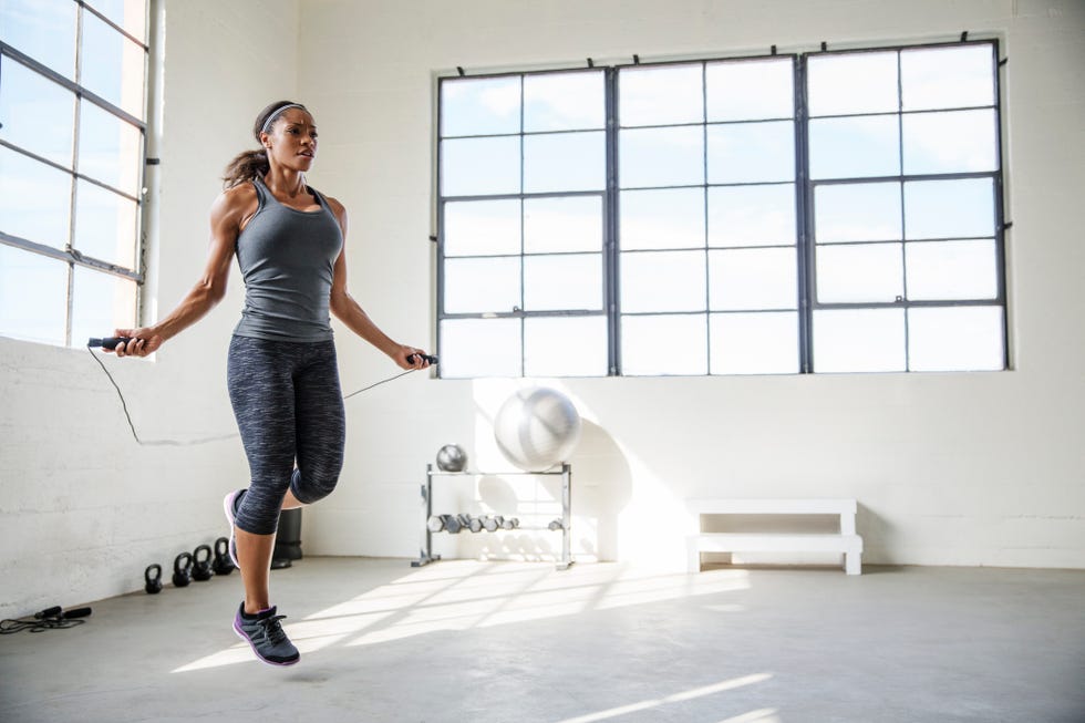 A Fit body, healthy and athletic woman in studio holding mat and