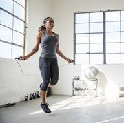 female athlete skipping with jumping rope in gym
