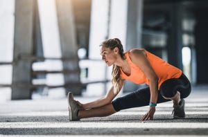 female athlete stretching outdoors