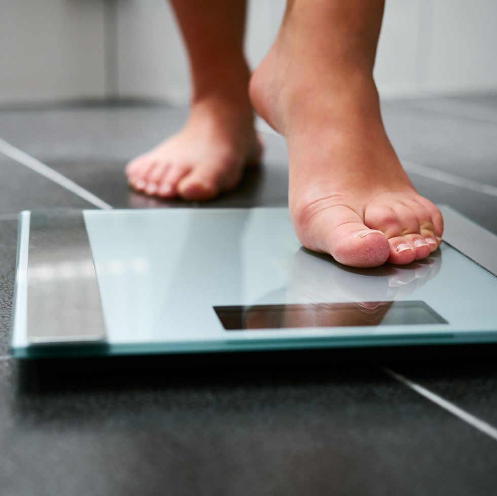 Female bare feet with weight scale