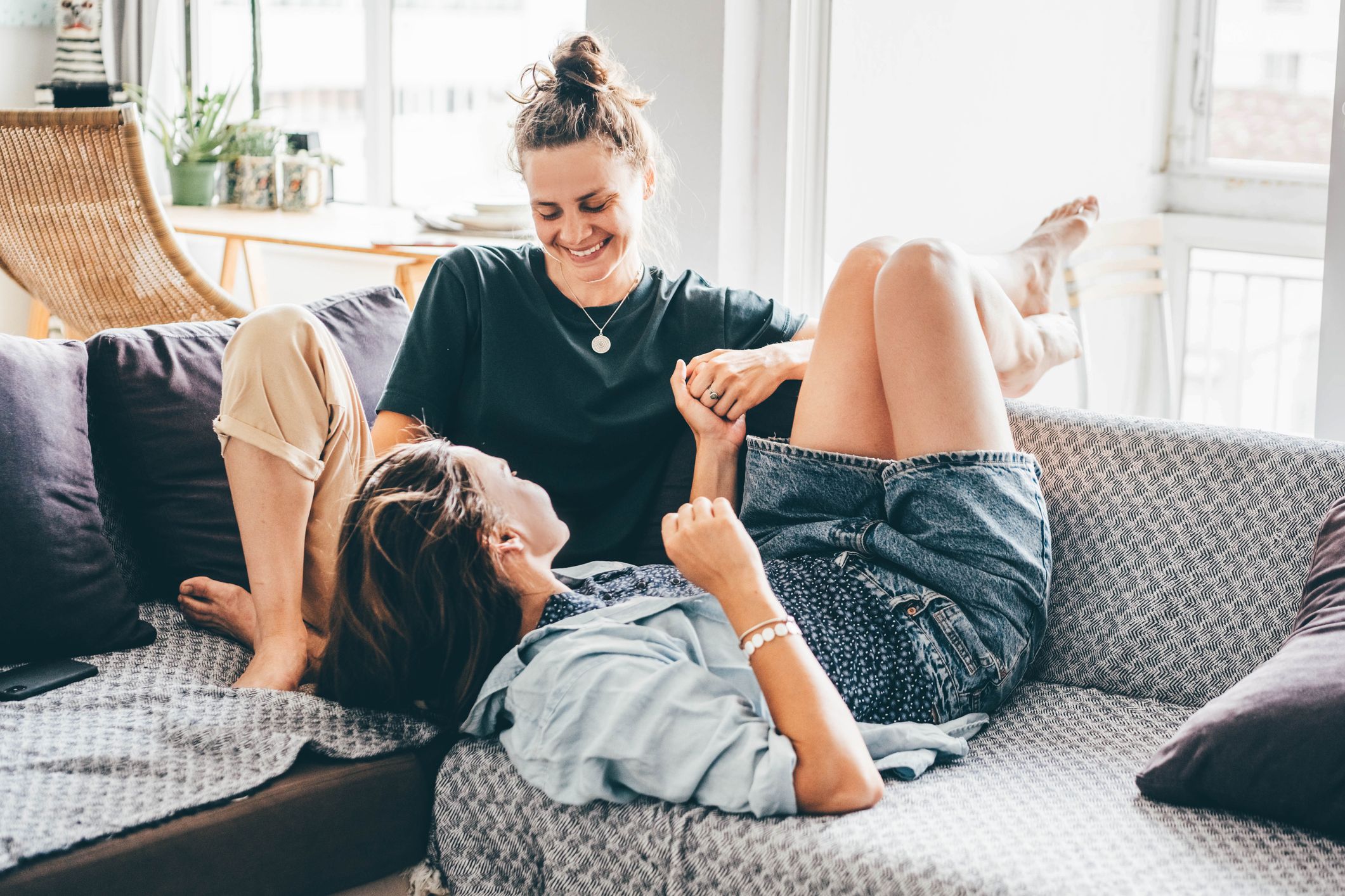 female couple enjoying time together on a sofa