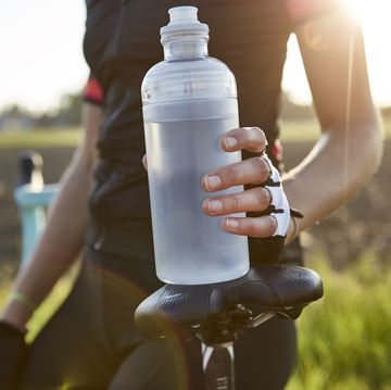 female cyclist holding water bottle