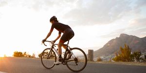 Female cyclist riding early in the morning