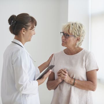 female doctor delivering news to mature female patient