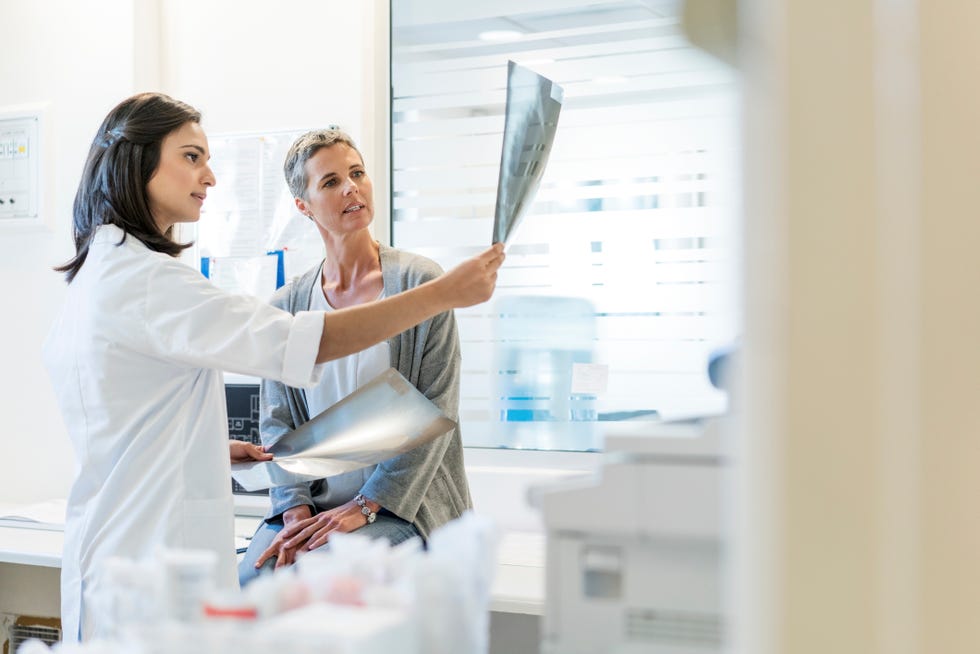 female doctor explaining x rays to mature patient