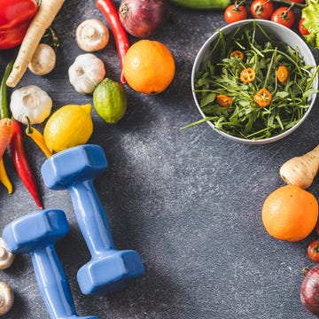 female dumbbells, vegetables and fruit