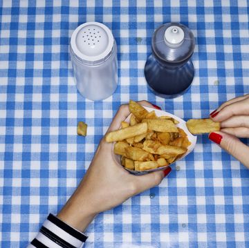 Female eating chips with salt and vinegar
