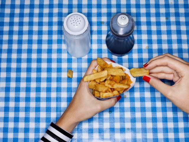 Female eating chips with salt and vinegar