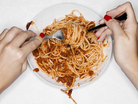 female eating spaghetti, overhead view