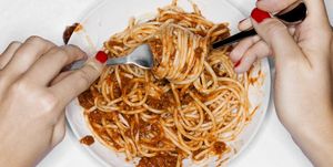 female eating spaghetti, overhead view