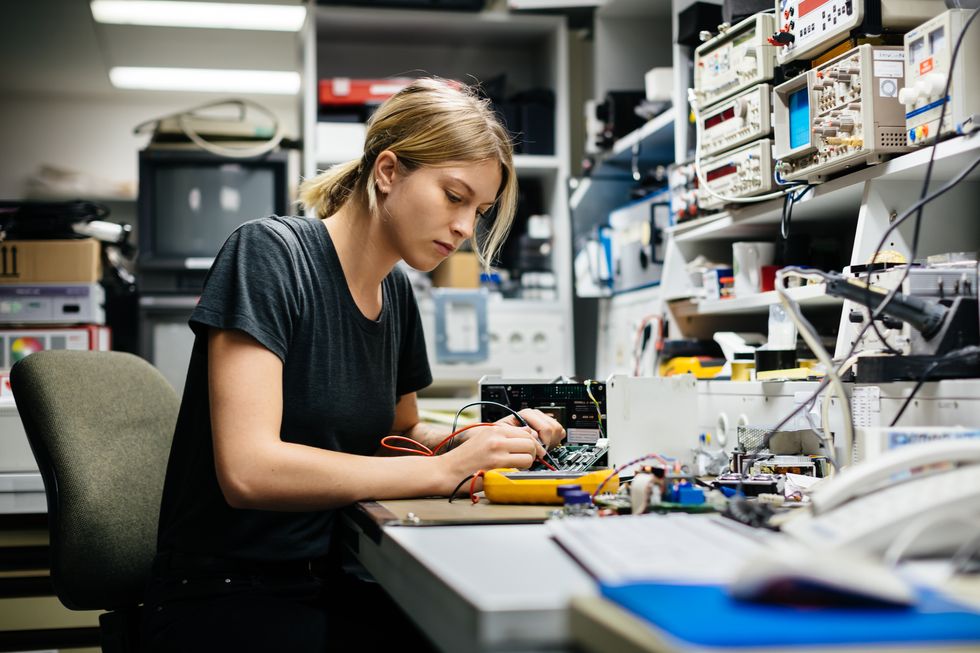 female engineer measuring voltage