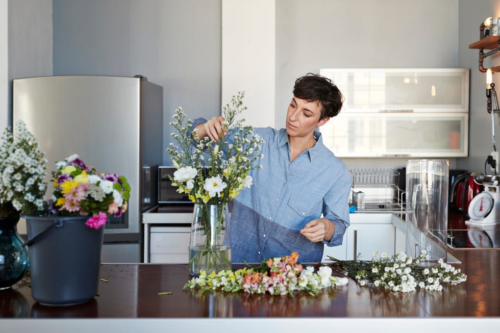 hobbies for women - Female florist organising flowers for customer from home