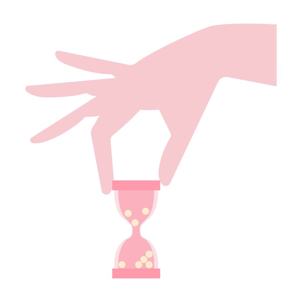 female hand holding hourglass