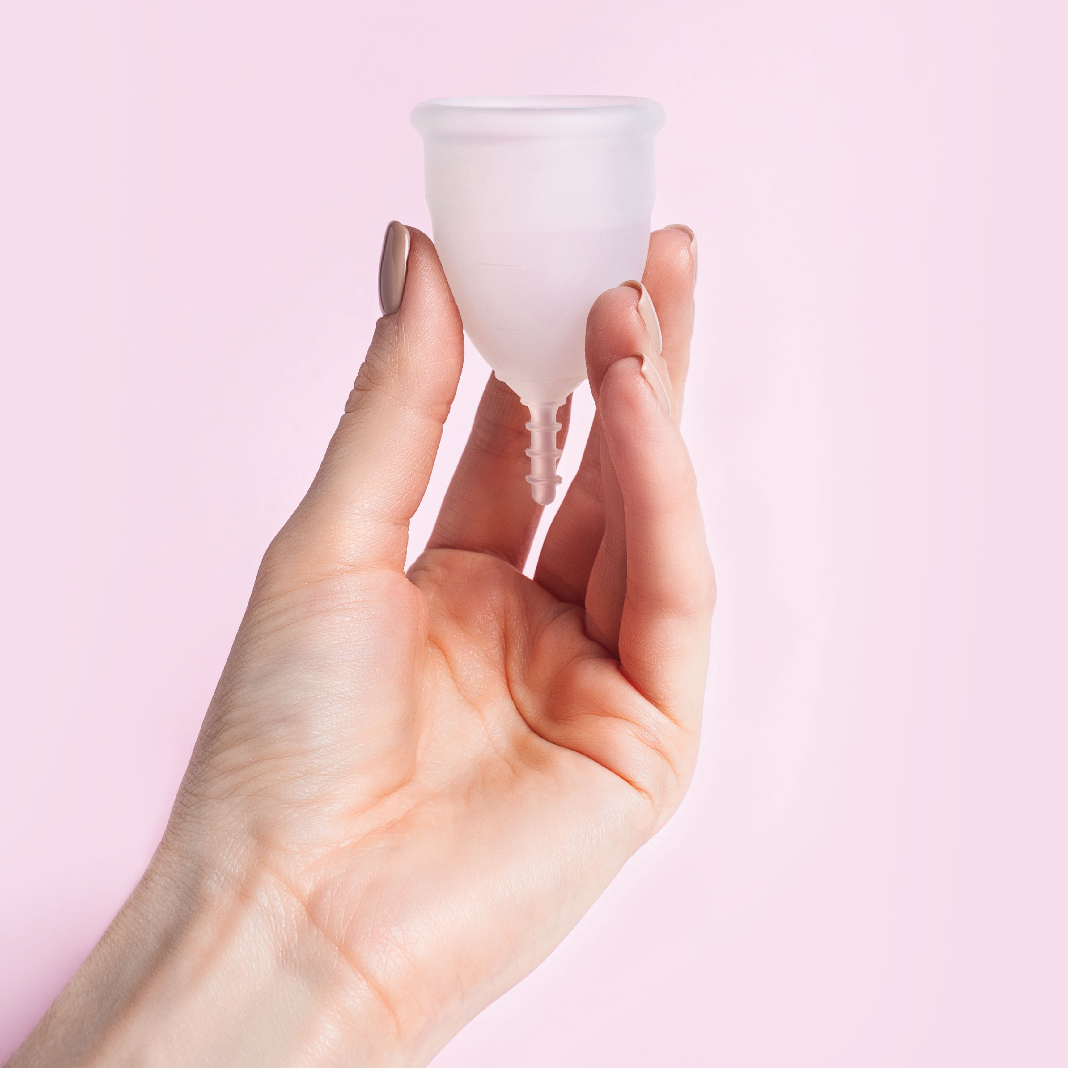 female hand holds silicone menstrual cup reusable intimate hygiene