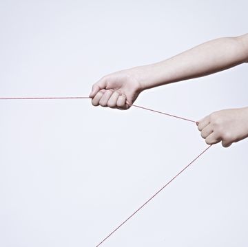 female hand pulling string