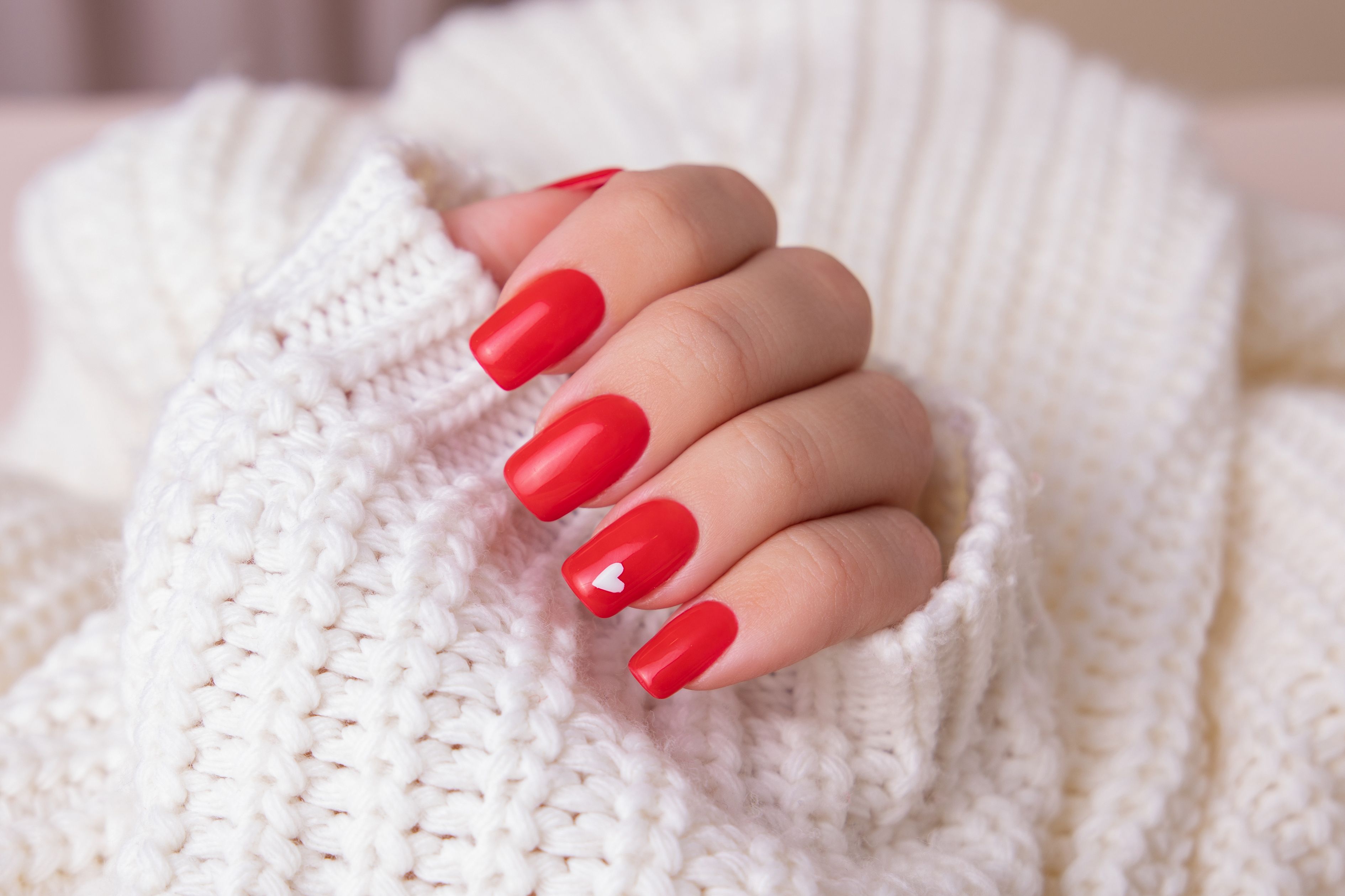 female hand with red manicure nails hearts design royalty free image