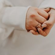 female hands nervously folded into each other, unrecognizable person, selective focus