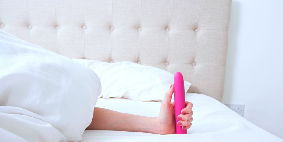 female holding dildo vibrator