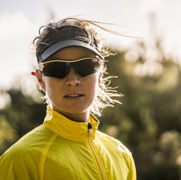 female jogger wearing sunglasses in forest