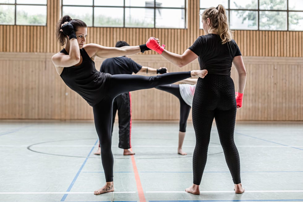 female kickboxers practising in sports hall