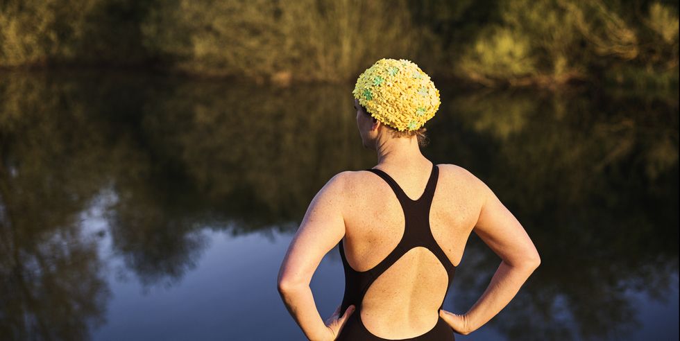 female open water swimmer by a lake