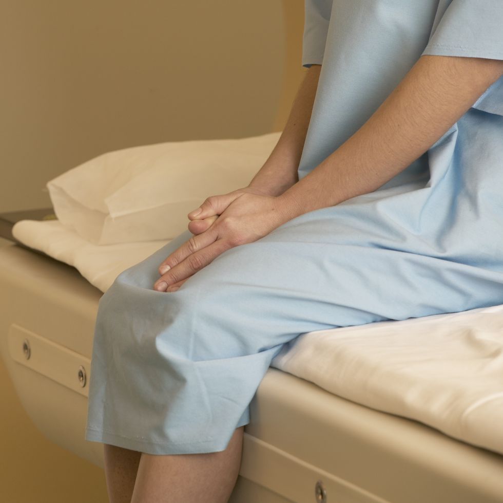 Female patient sitting nervously on scanner bed