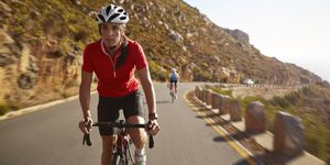 female pro cyclist taking lead on mountain climb