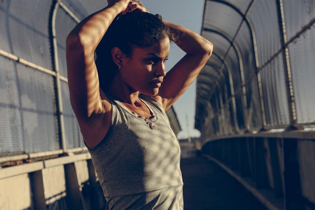 female runner adjusting ponytail before run