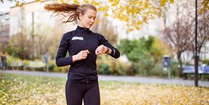 Female runner checking smartwatch while running