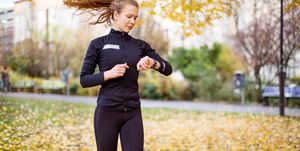 Female runner checking smartwatch while running