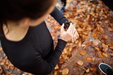 Female runner looking at smart watch heart rate monitor