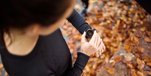 Female runner looking at smart watch heart rate monitor