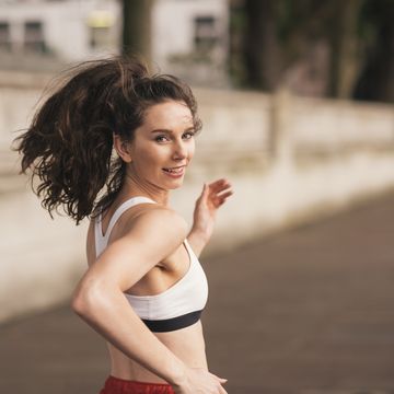 Female runner looking over her shoulder whilst running