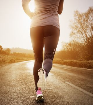 female runner running along road