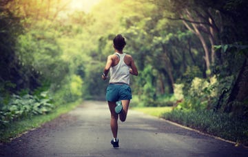 female runner running at summer park trail  healthy fitness woman jogging outdoors