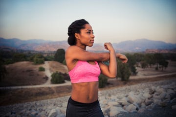 female runner stretching before exercise