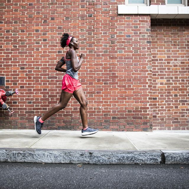 female running through urban area
