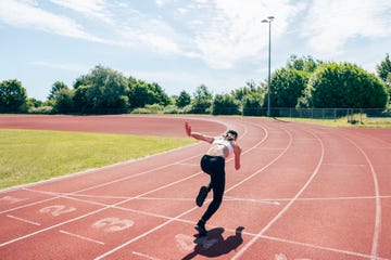 female sprinter taking first stride out of starting position