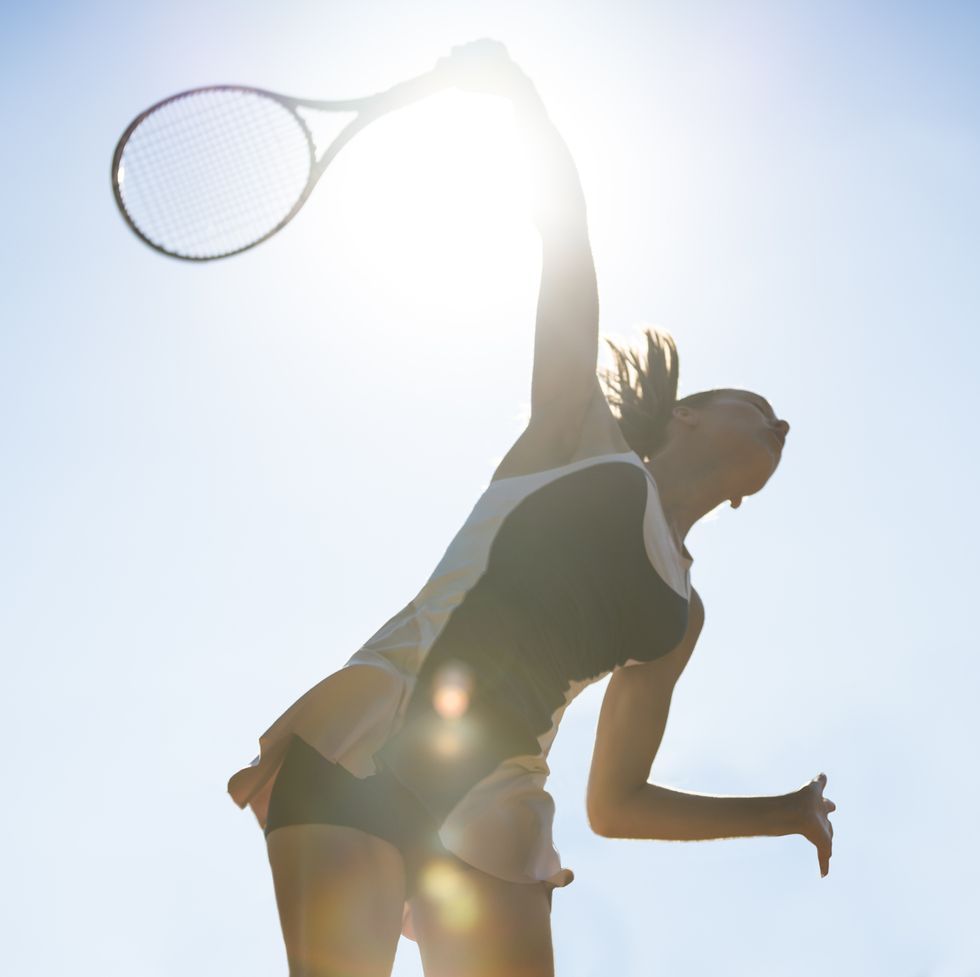 female tennis player about to hit a serve