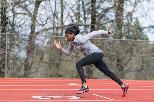 Female track athlete training at stadium