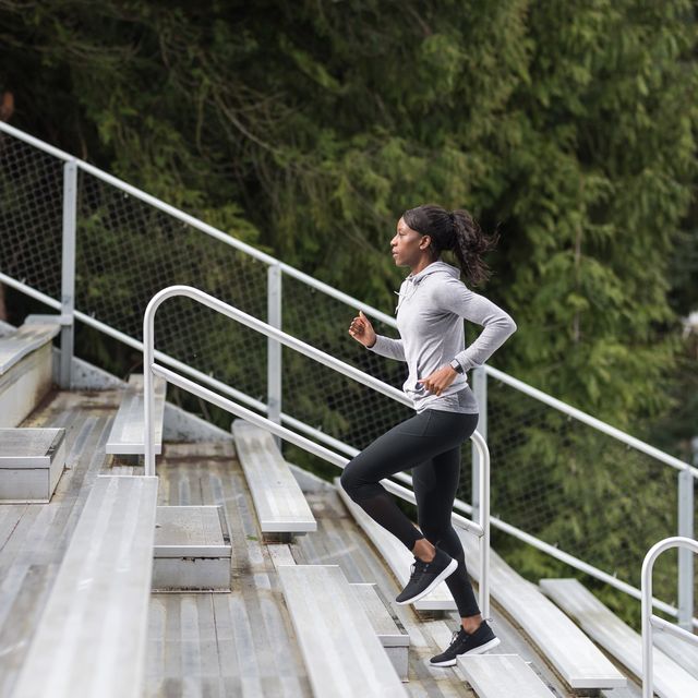female track athlete trains on stadium bleachers