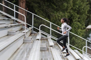 female track athlete trains on stadium bleachers