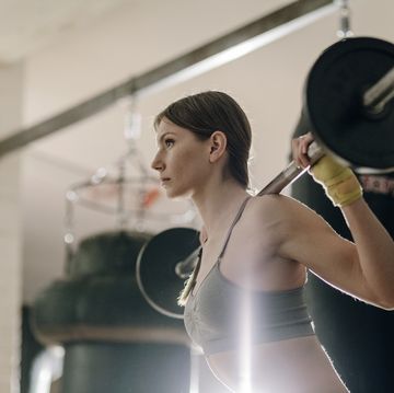 female weight lifting with barbell