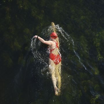 female wild swimmer in river great ouse