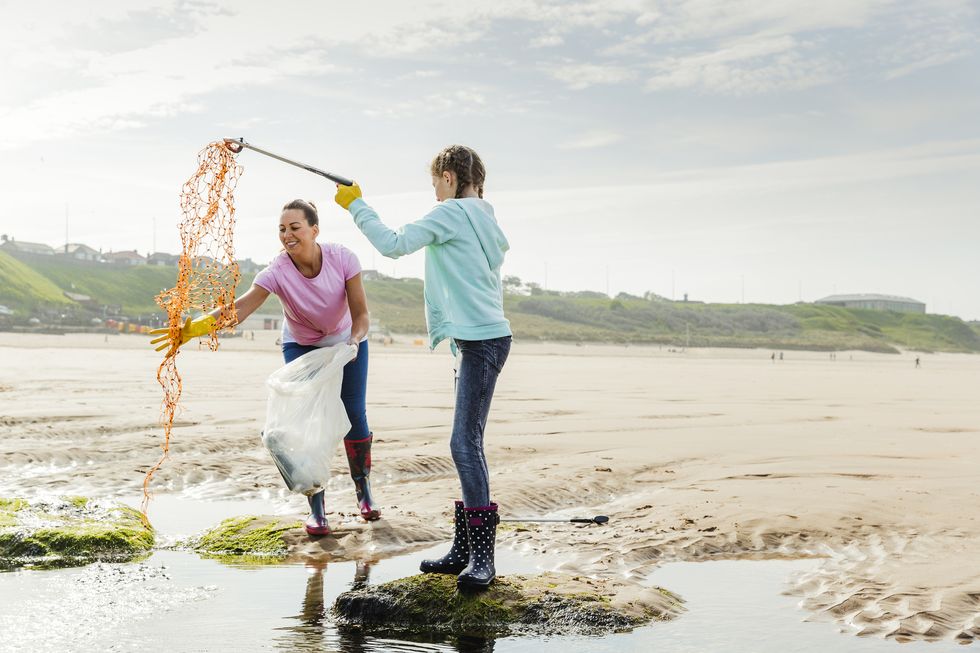 Females Collecting Plastics and Rubbish Off a Beach