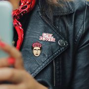 leather jacket with girl power and frida kahlo pins