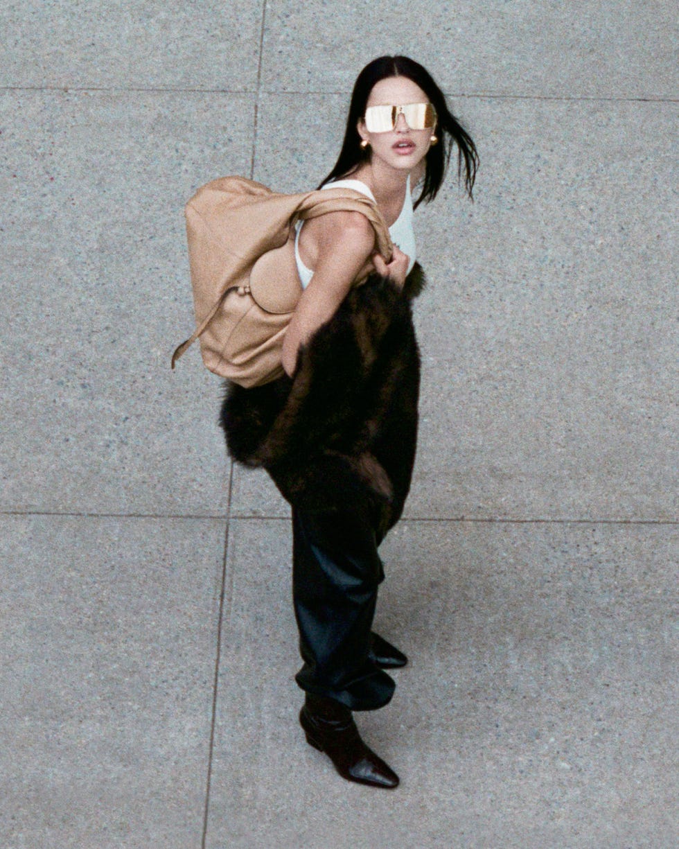 a person wearing stylish attire and carrying a backpack